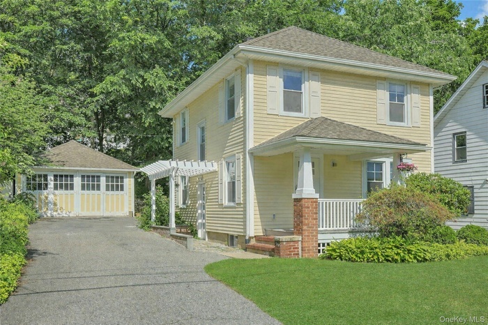 Covered front porch, side entry with pergola and 2 car detached garage.