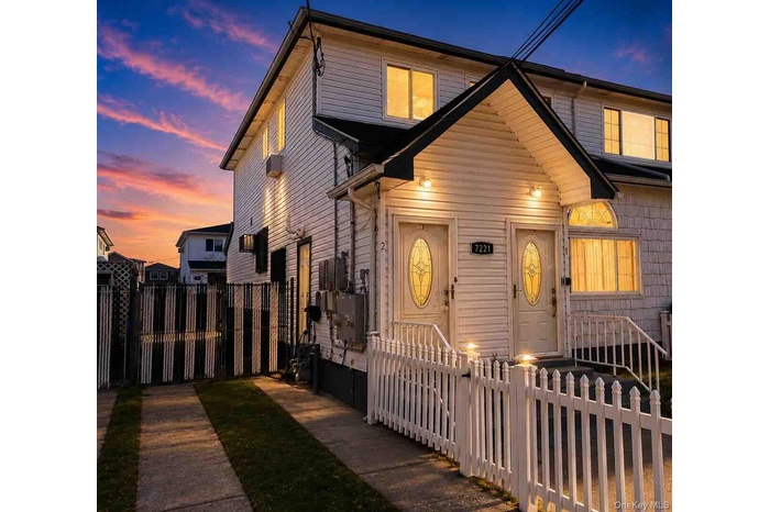 Two-story exterior with white siding and contrasting black trim