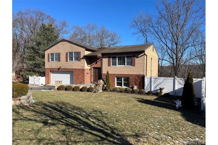 View of front of home featuring a garage and a front lawn