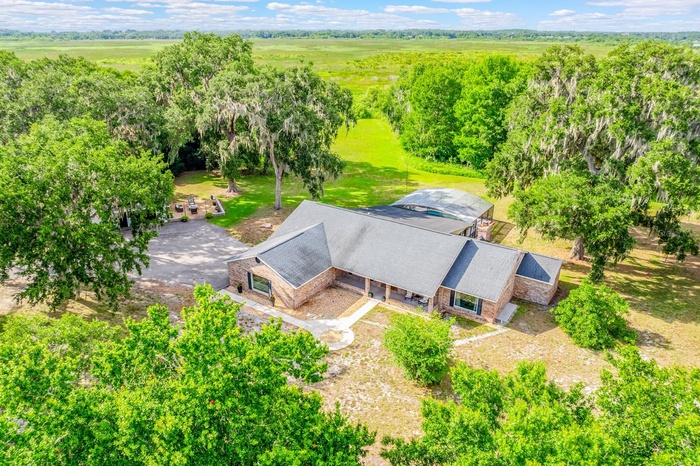 Peaceful, private, and packed with possibilities, this beautifully updated POOL HOME sits on TWO PARCELS totaling 5 ACRES with a PRIVATE GATED ENTRANC