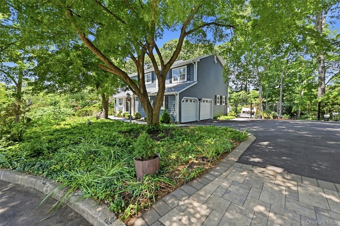 Driveway with paver apron, side of home, garage doors