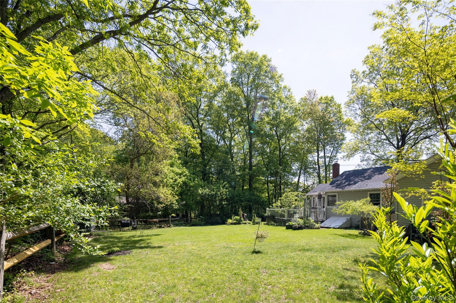 Rear yard with split rail fence and bilco entrance