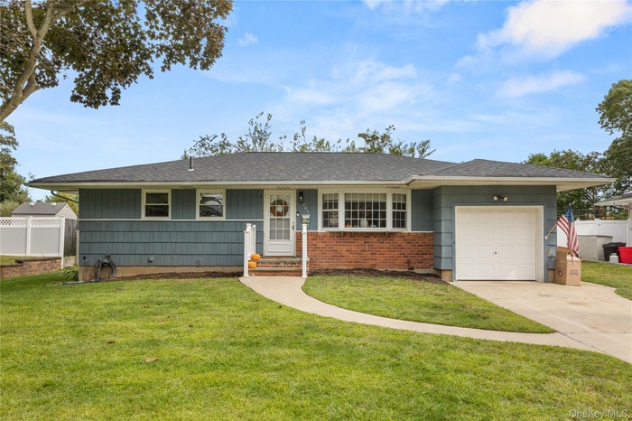 Ranch-style house with an attached garage, concrete driveway, and roof with shingles