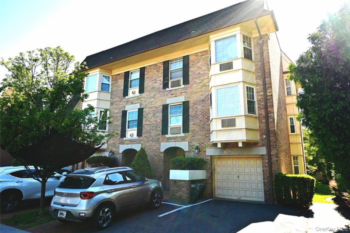 Brick exterior featuring multiple windows and shutters