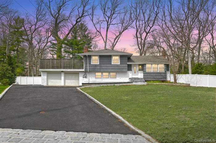 Expanded split level home featuring a 2+ car garage on a .5 acre lot on a quiet cul de sac