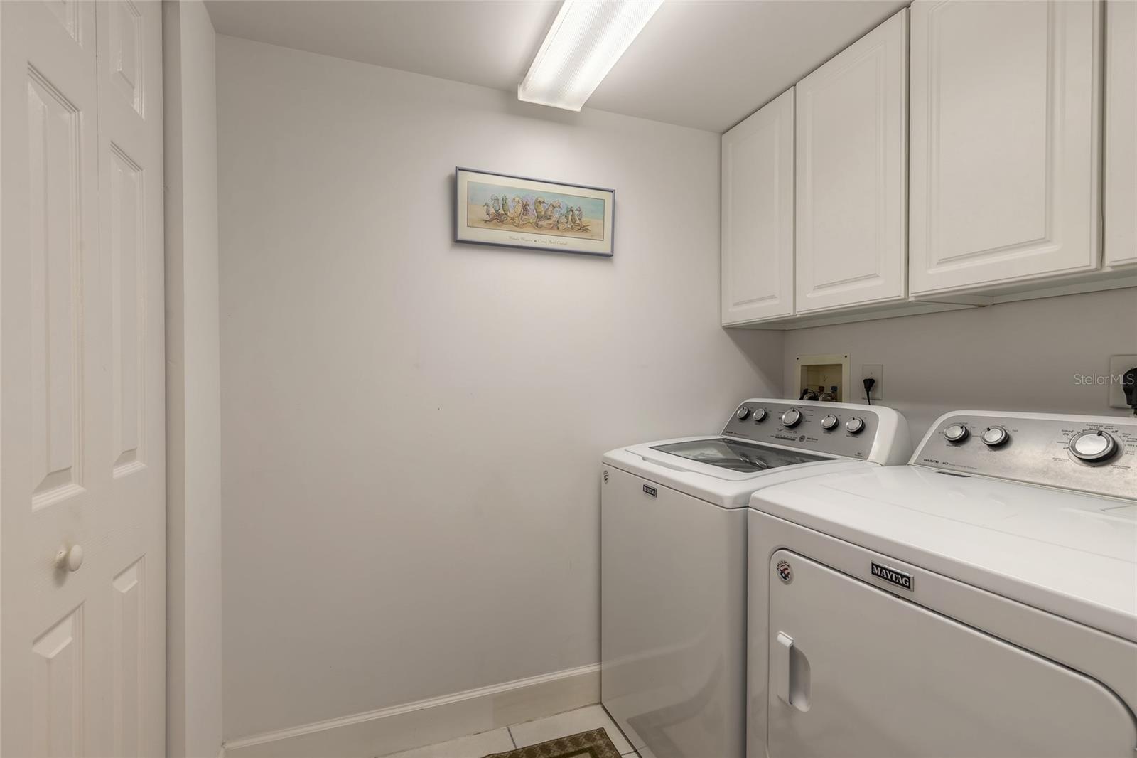 In unit laundry room with storage