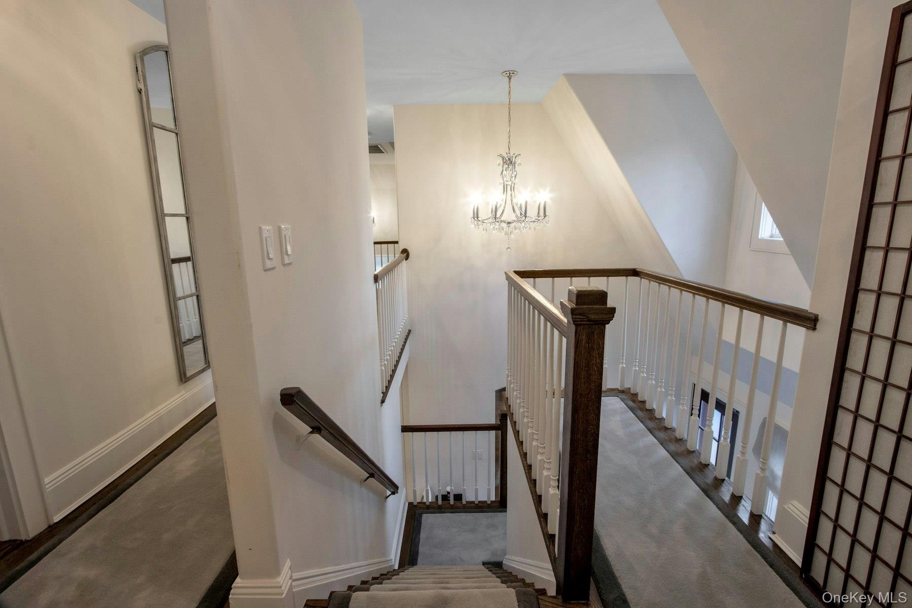 Stairway featuring a chandelier and a high ceiling