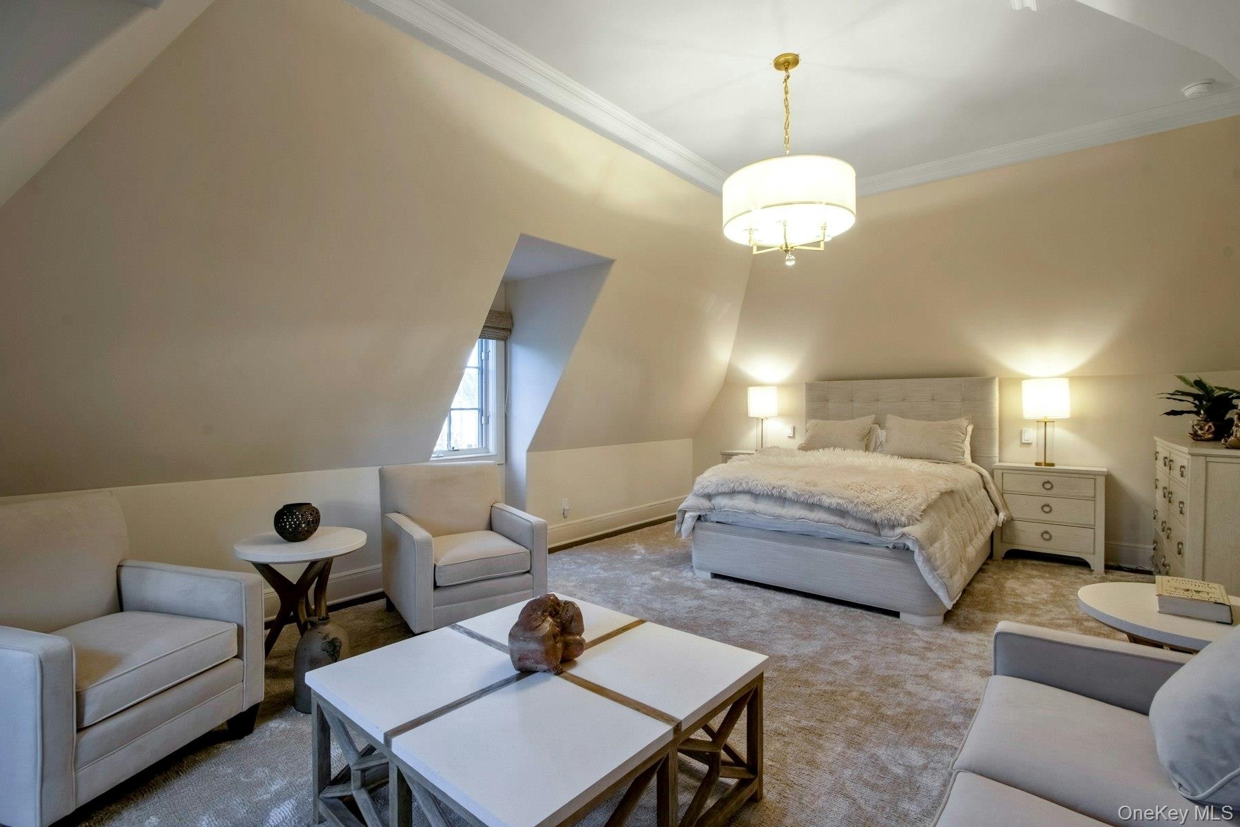 Carpeted bedroom featuring lofted ceiling and ornamental molding
