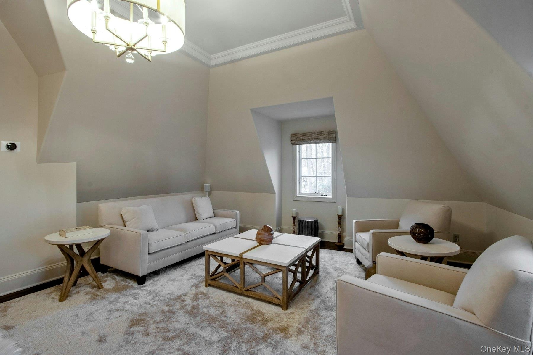 Bedroom featuring vaulted ceiling, light hardwood / wood-style flooring, a notable chandelier, and crown molding