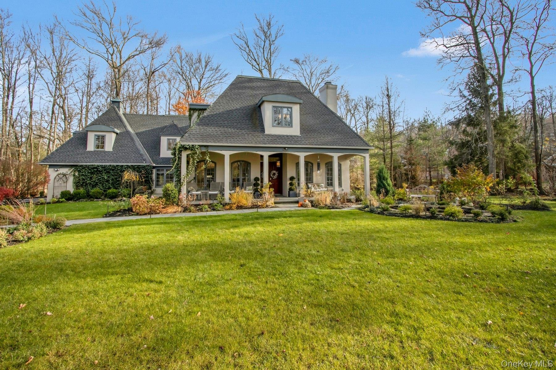 View of front facade featuring a front lawn and covered porch