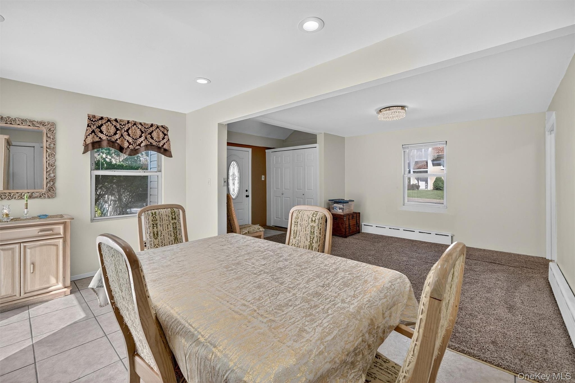 Dining space featuring baseboard heating, light tile patterned flooring, recessed lighting, and a baseboard radiator