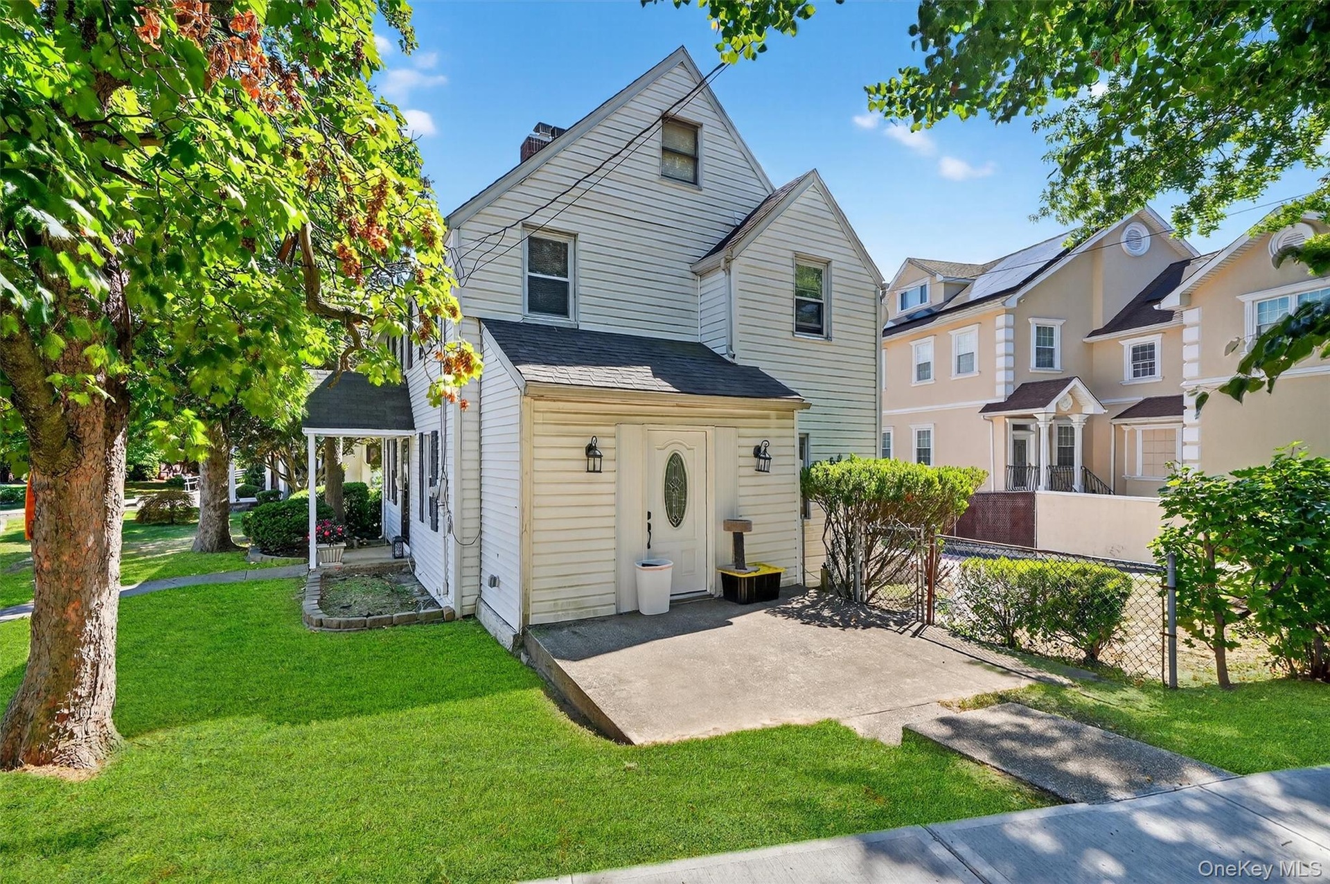 Traditional home with roof with shingles, a front lawn, and a chimney