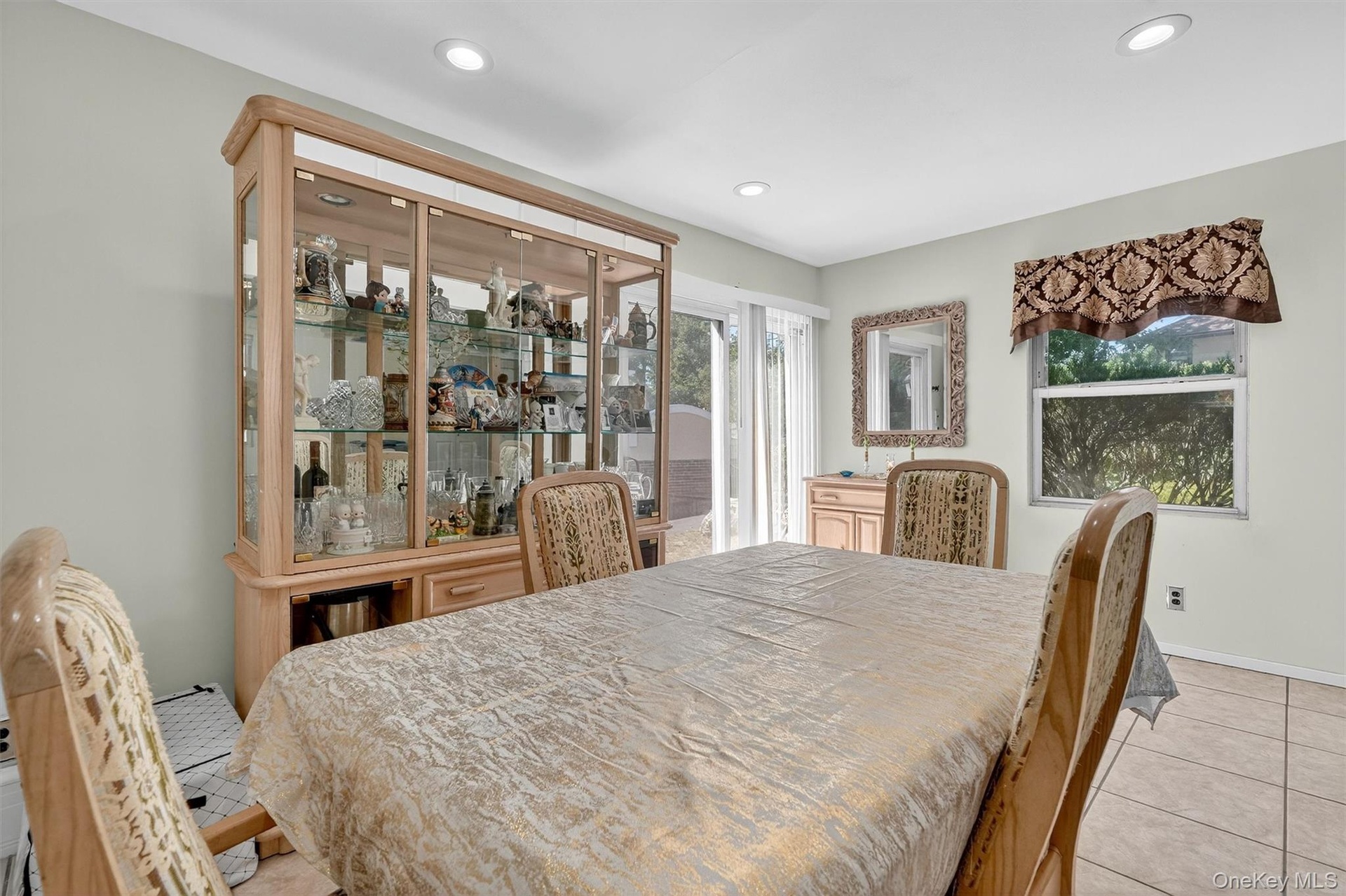 Dining room featuring light tile patterned flooring and recessed lighting