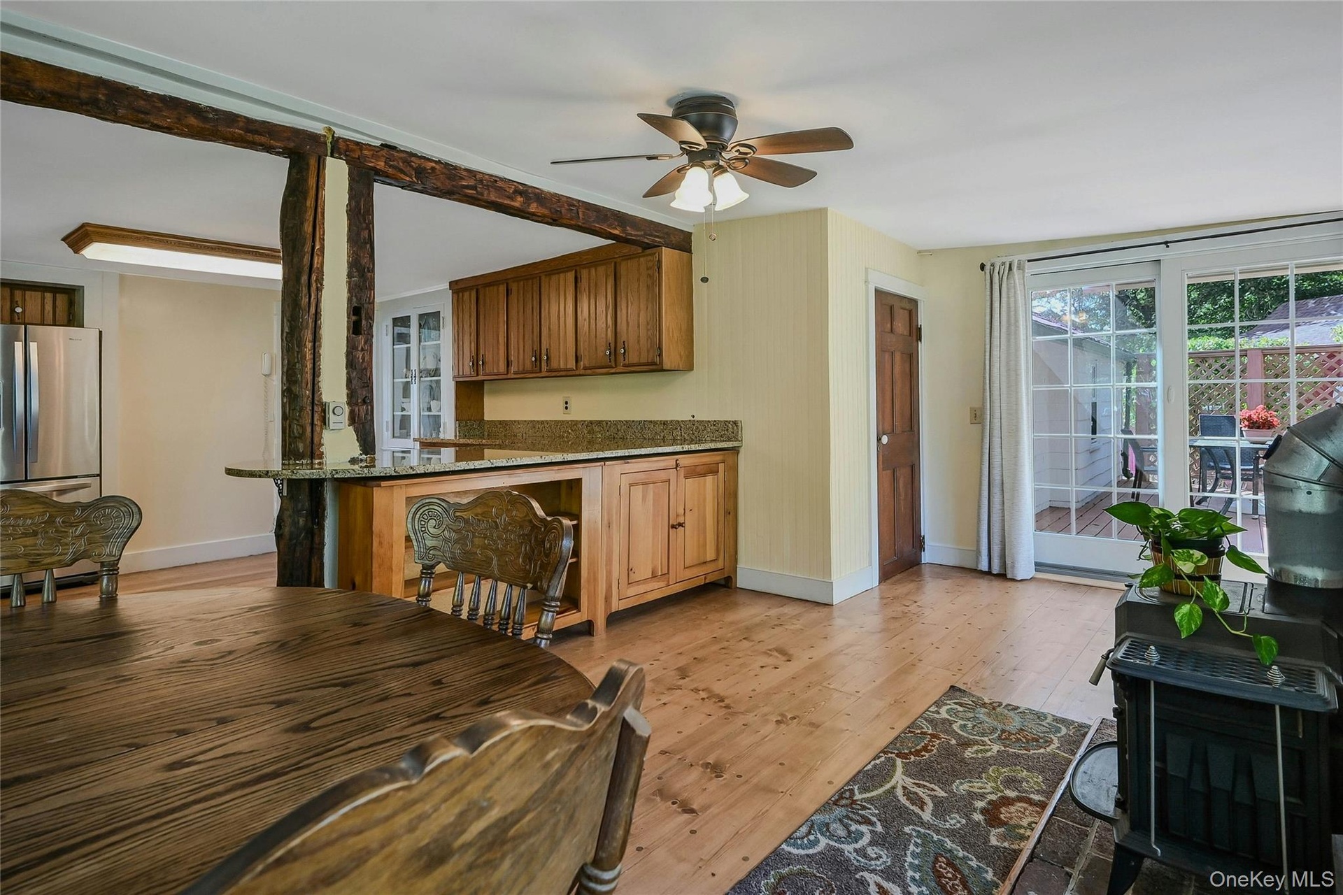 Den with access to the back deck and wood burning stove