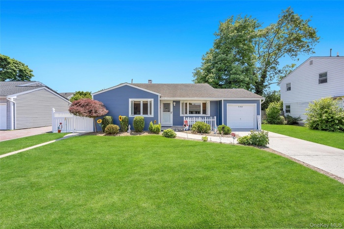 Split Level residence featuring blue siding and a well-maintained front lawn