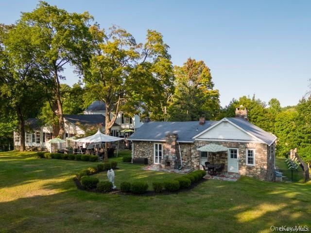 Rear view of property with a lawn