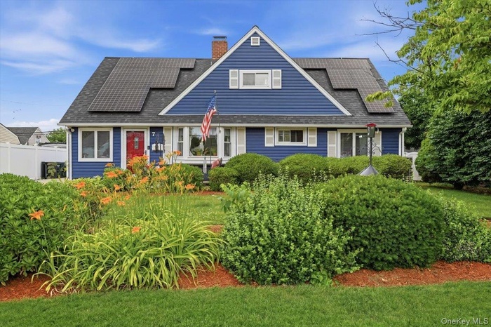 Blue siding exterior with white window trim and shutters