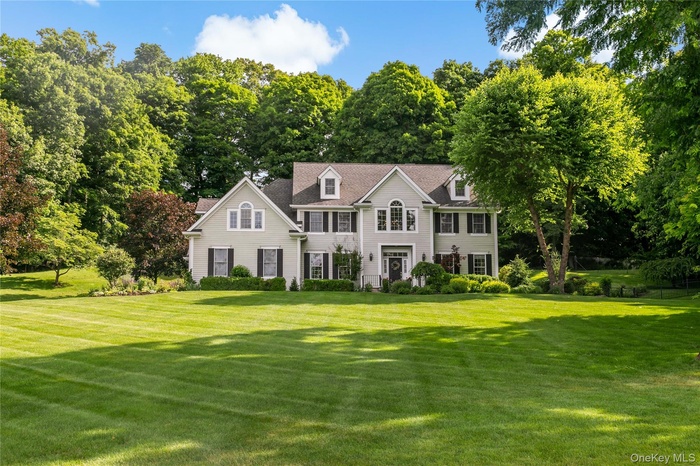 Spectacular center hall colonial sitting stately on the grounds.