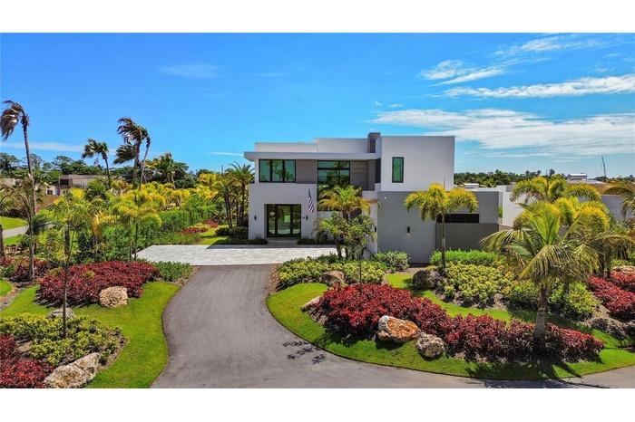 Nestled on a quiet cul-de-sac and offered fully furnished, this exceptional two-story residence combines elegant design, resort-style amenities, and c
