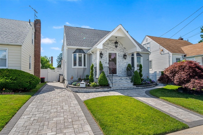Charming residential exterior with stone facade accents and decorative outdoor lighting