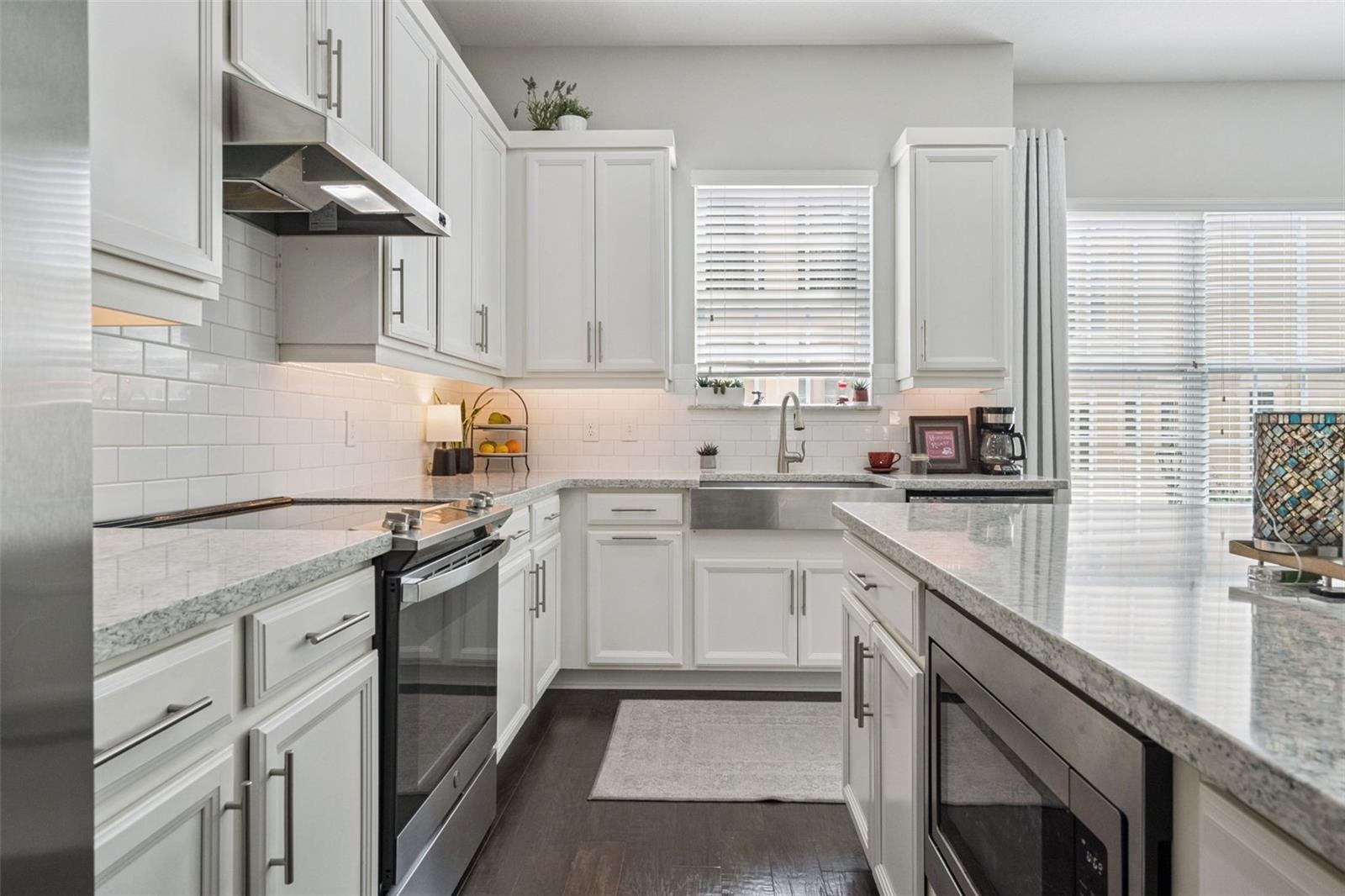 Kitchen with quartz countertops and steel farmhouse sink