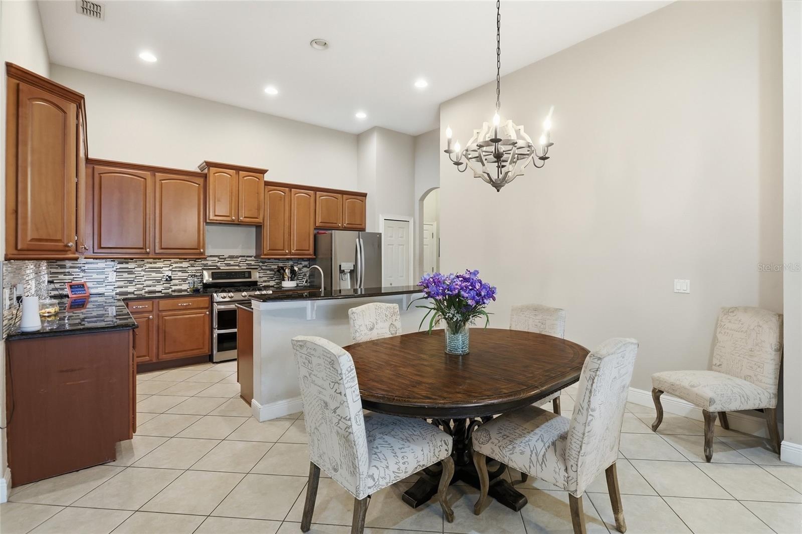 Open kitchen with 42" cabinetry, a gas range, and expanded pantry