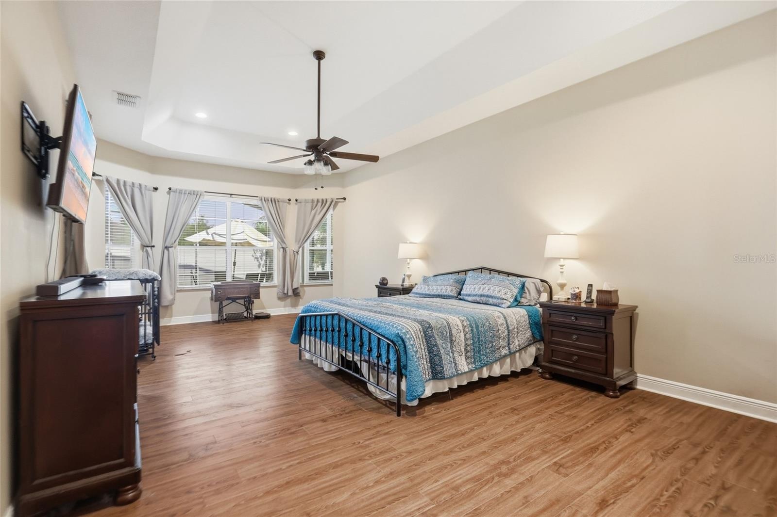 Private primary suite with large picturesque windows allowing a view of the backyard