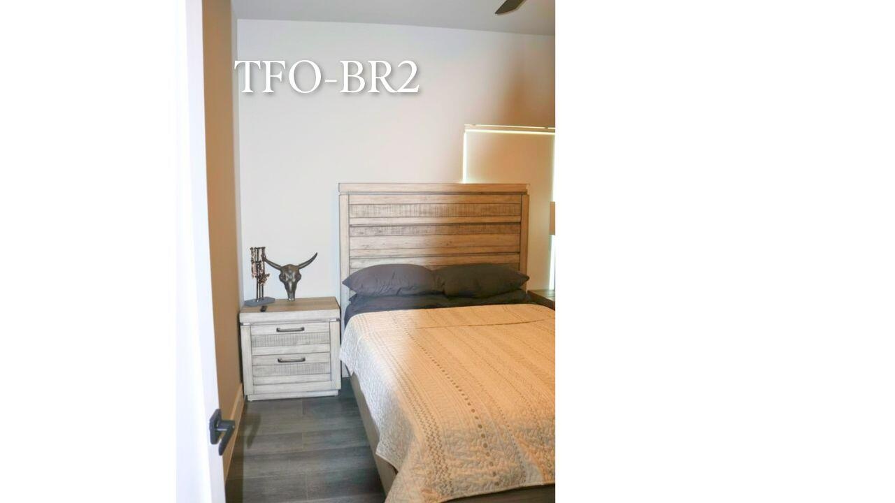 Located at the end of the hallway, this guest bedroom offers a queen-size bed, remote-controlled blackout blinds, and a quiet retreat for family or vi