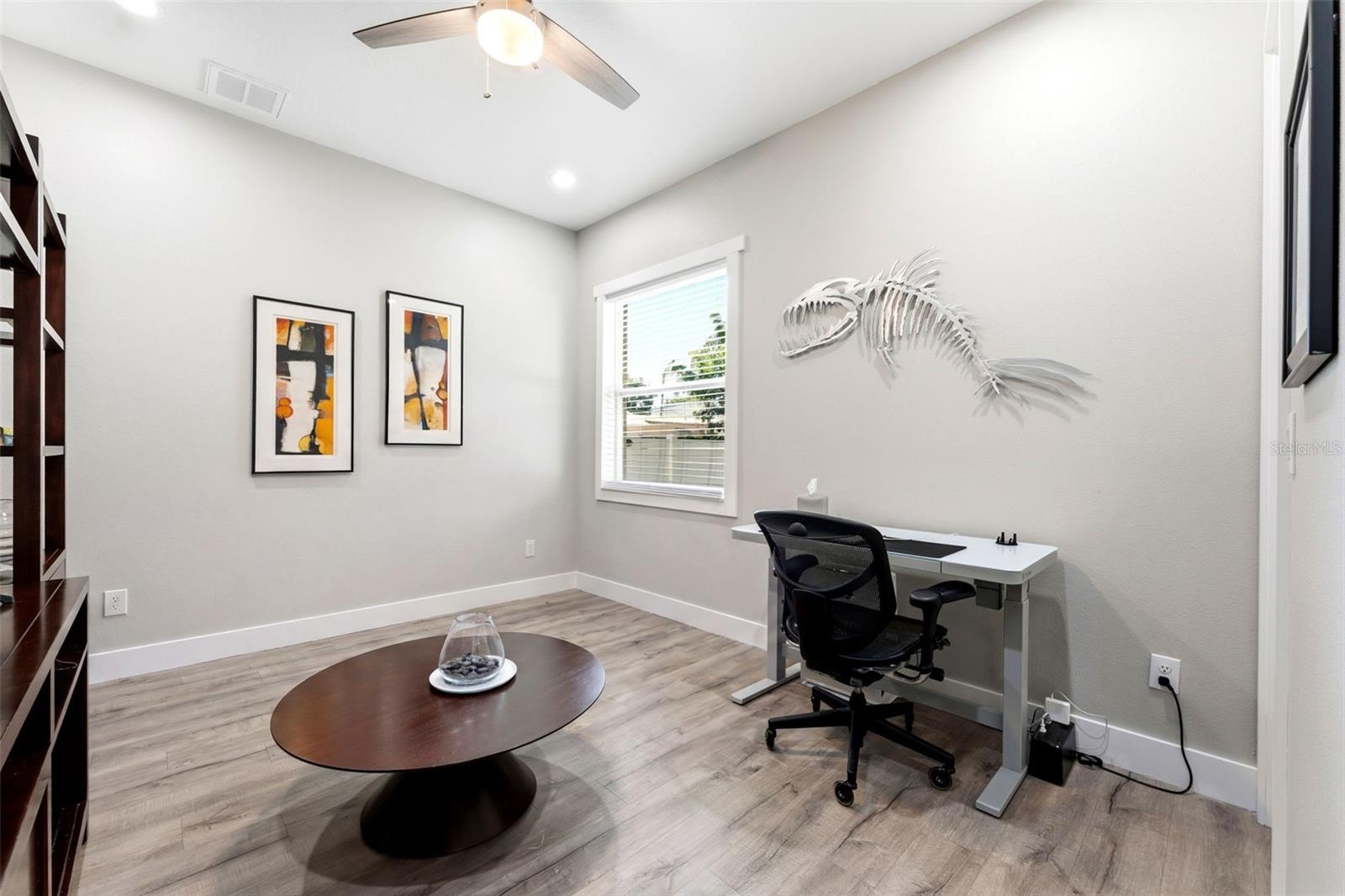 Main-floor bedroom with its own full bath flexes perfectly as a home office, in-law suite, or private retreat for visitors