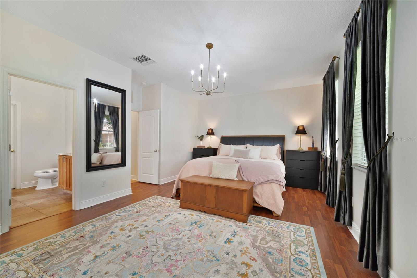 The spacious MAIN FLOOR PRIMARY SUITE offers 4 windows that let the natural light pour in, a WALK-IN CLOSET and well-appointed private en-suite bath.