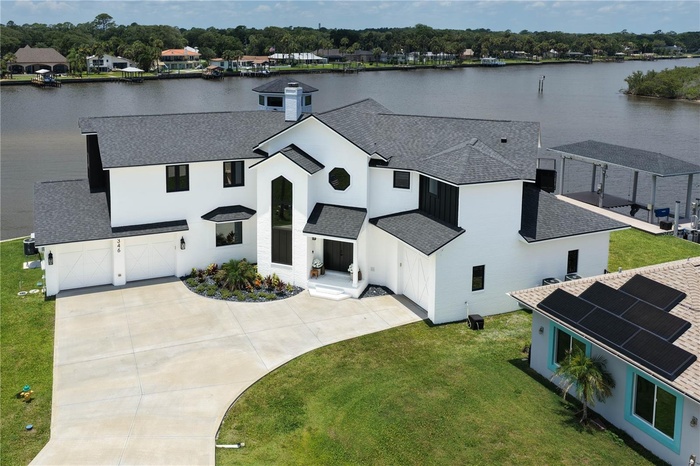 A spectacular tip-lot location on the Matanzas River provides panoramic water views and a stunning backdrop for this architecturally distinctive water