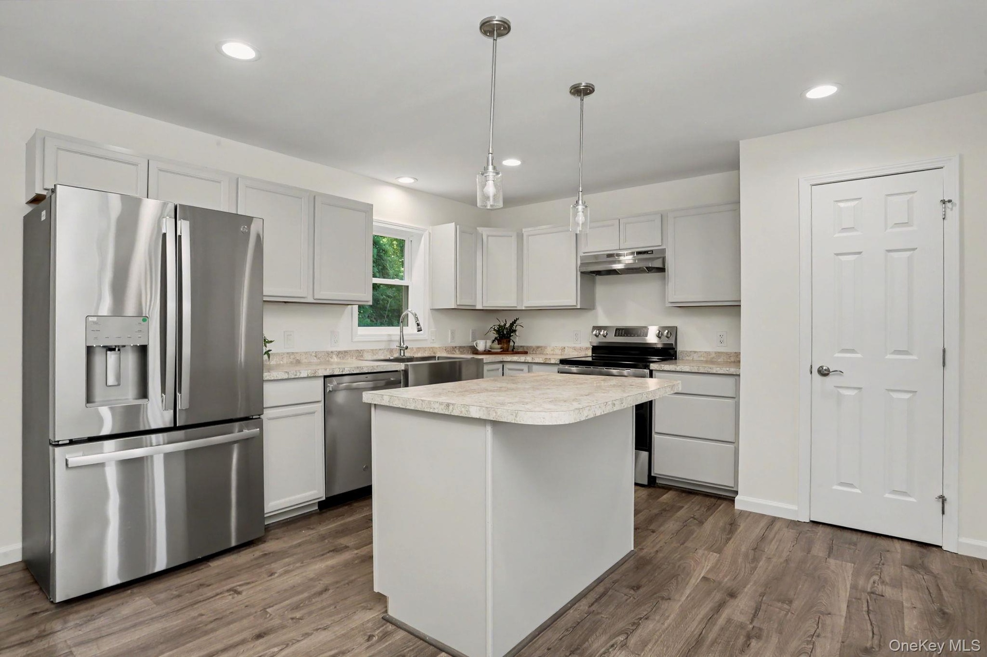 Kitchen with stainless steel appliances and pantry closet