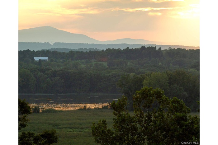 View of mountain feature featuring a water view and a wooded view