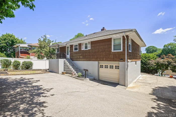 Exterior view from driveway with ample room for parking.