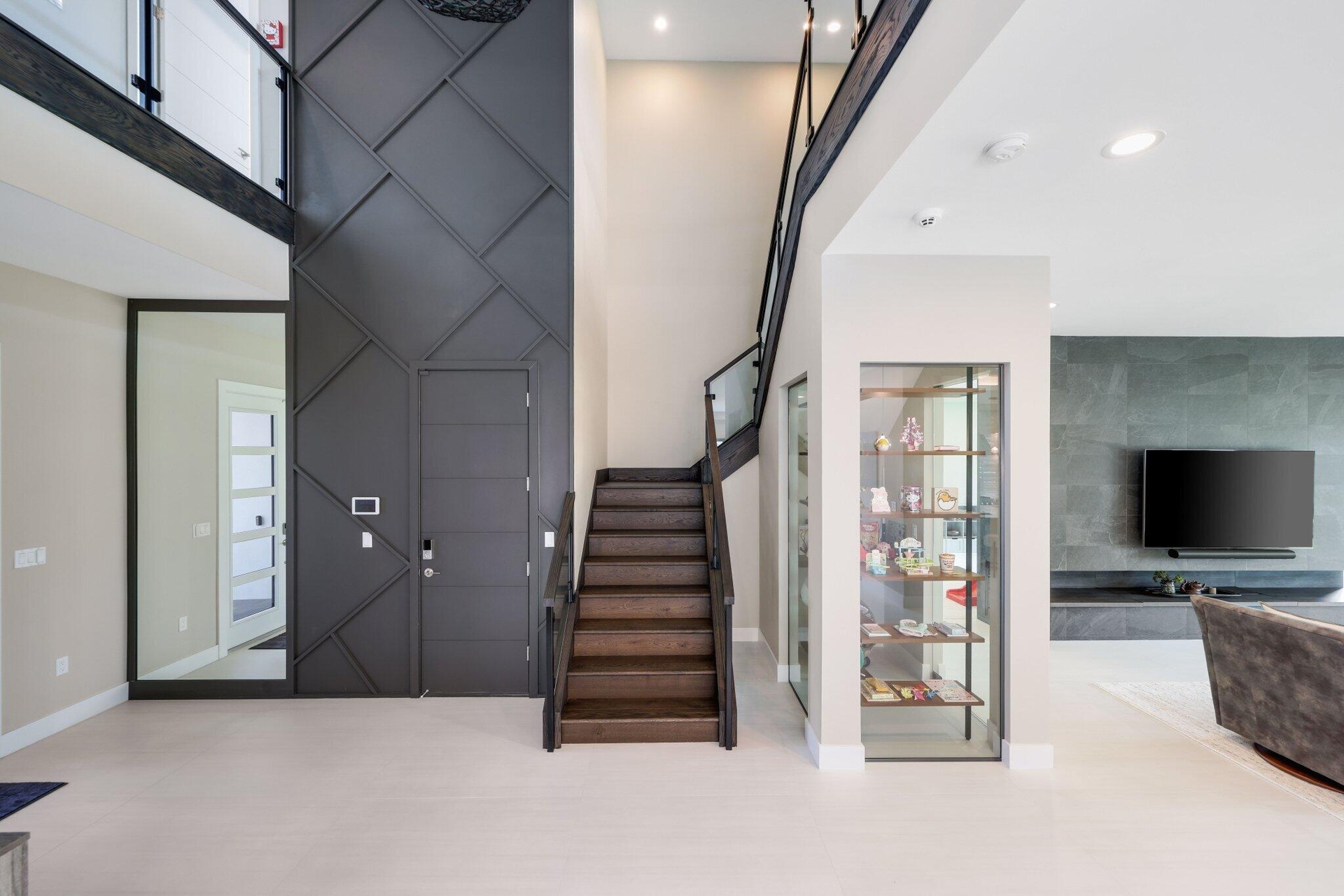 Lutron Automated Lighting throughout the entire house. Glass enclosed display room w shelving. Easy to make into a wine room.