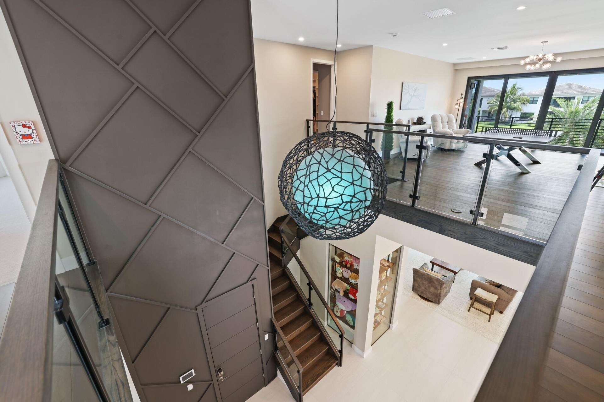 Custom floor to ceiling wall design. Wood floors on stairs and second floor