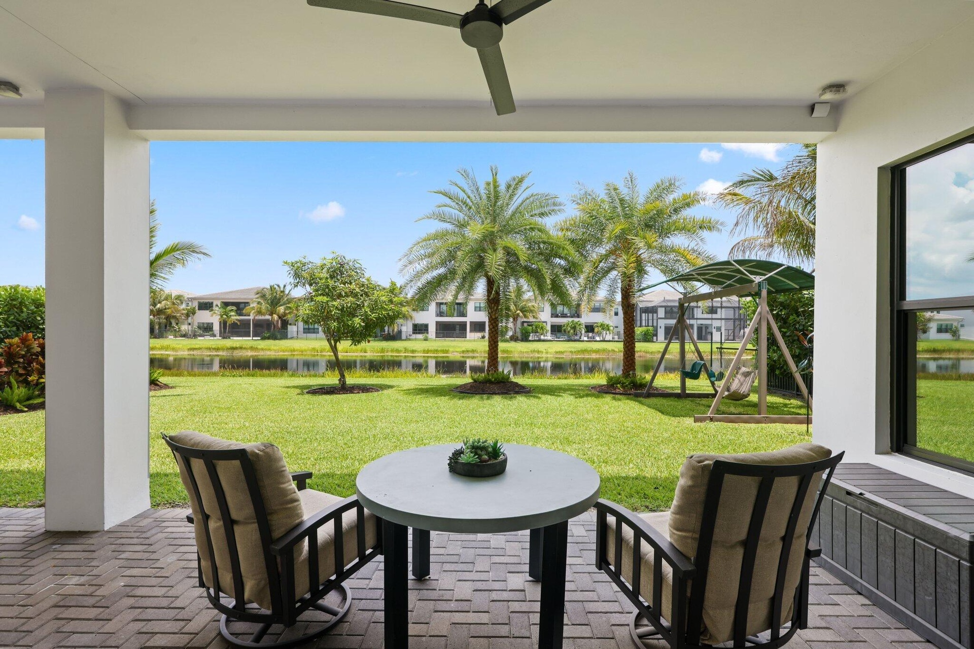 covered patio overlooking the backyard. Newly planted palm trees and a mango tree for extra shade in the backyard