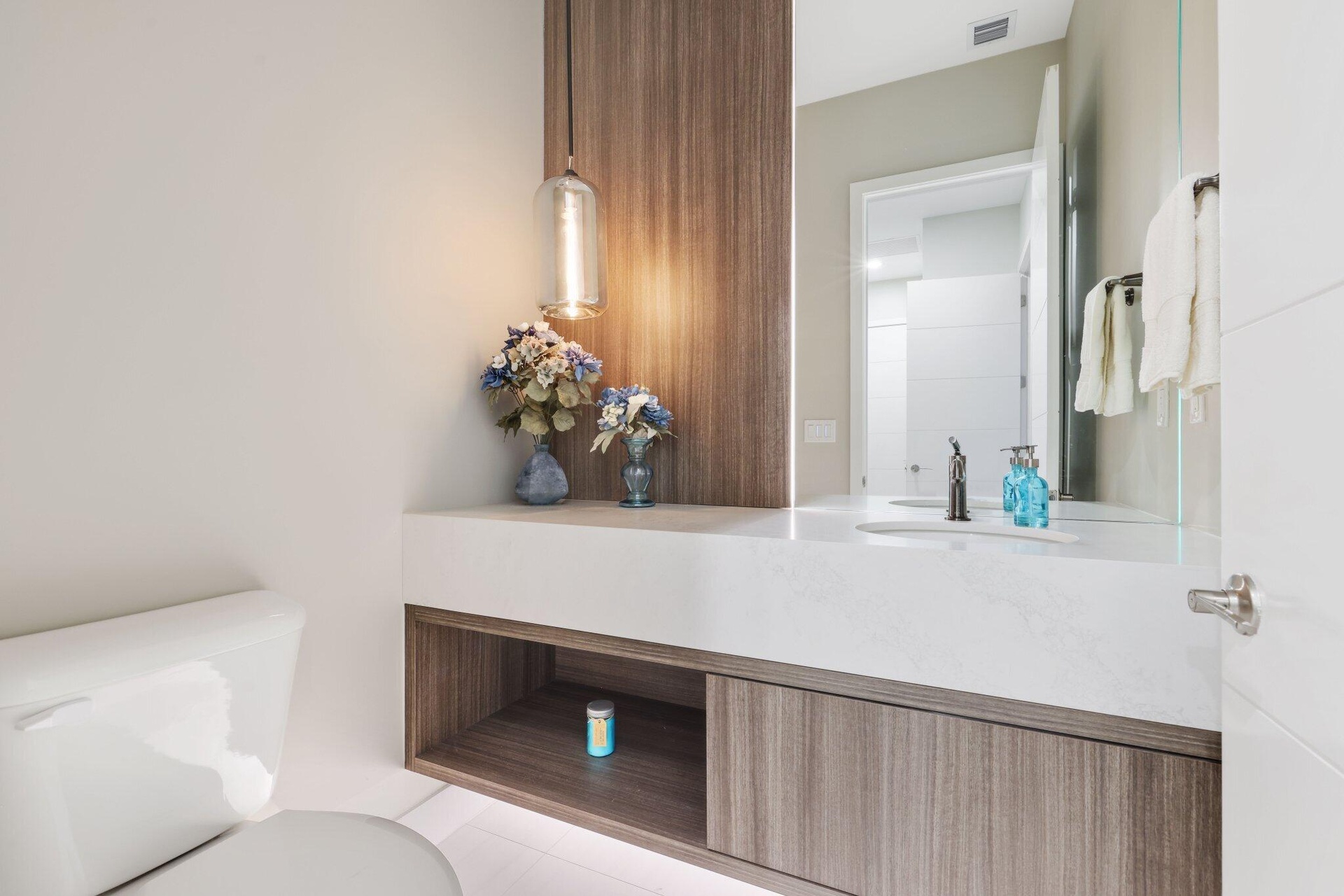 Powder Room. Removed the entire powder room and replaced with custom build. Floating cabinet, feature wall w panel, mirror and light strips.