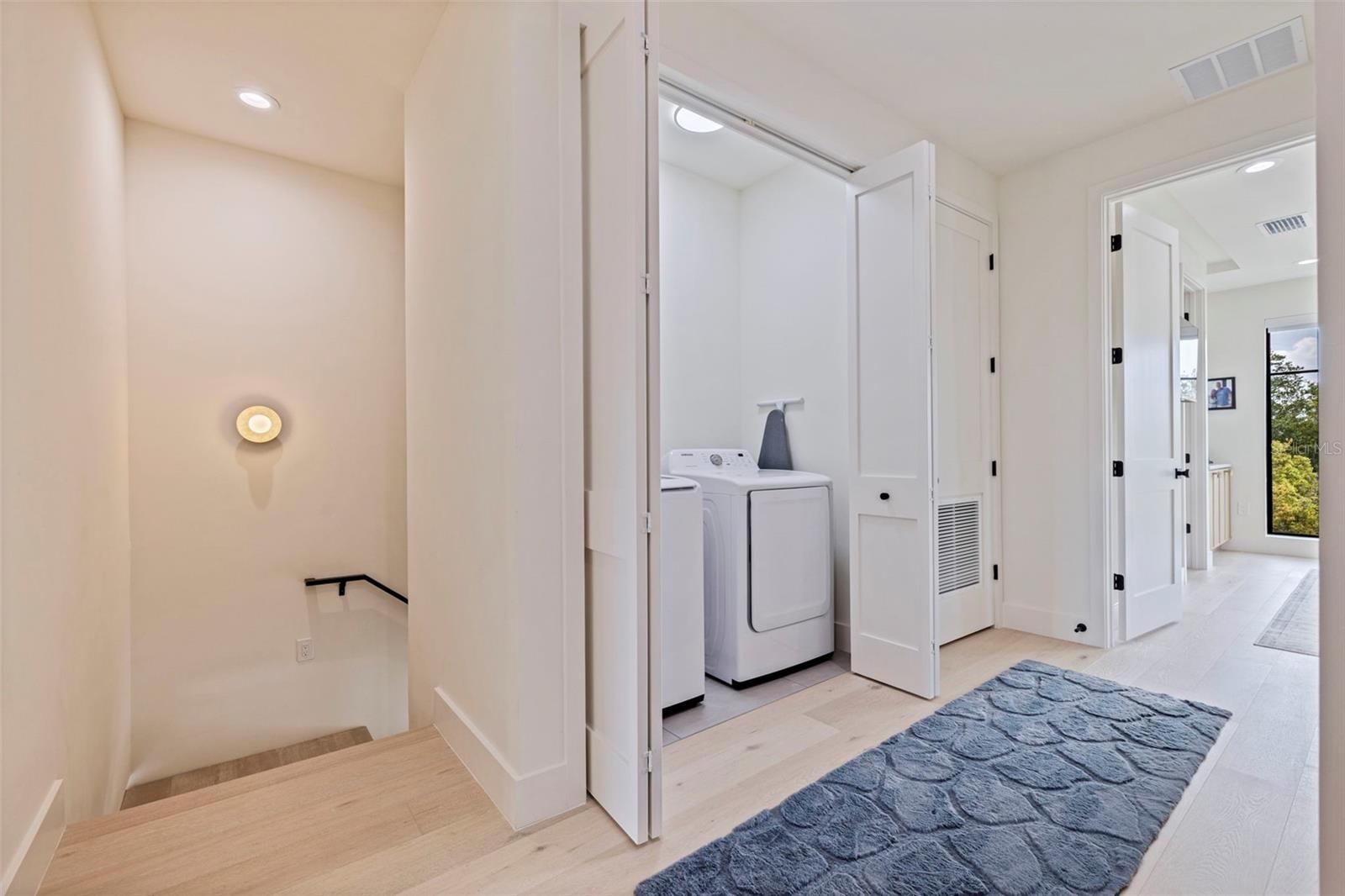 Laundry upstairs with primary bedroom
