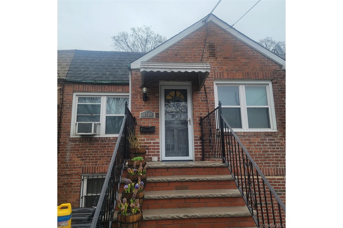 Doorway to property with brick siding