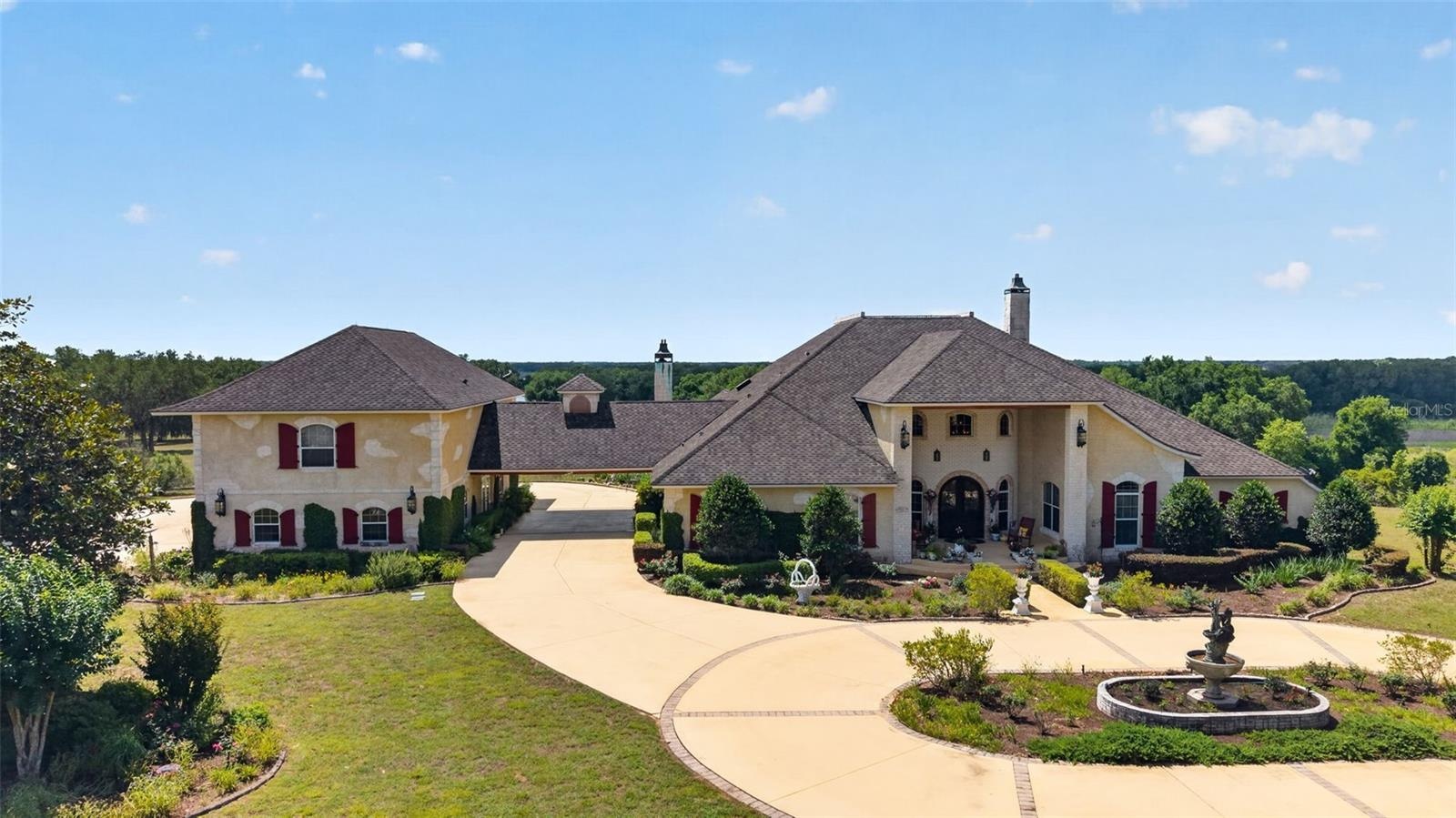 Aerial Front View of Home and 6 Car Garage and Guest Quaters
