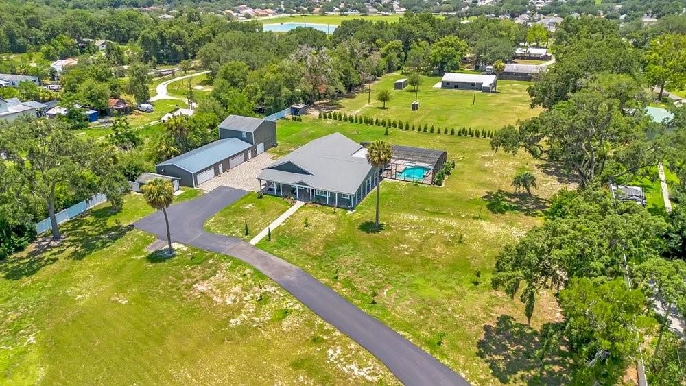 Aerial View of ADU, 6 car garage, Workshop (2 car space) and 2/1 guest unit with a loft and kitchenBrand new Hardie Board siding on ADU, metal roof on