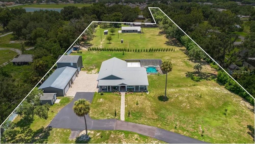 Aerial View of ADU, 6 car garage, Workshop (2 car space) and 2/1 guest unit with a loft and kitchenBrand new Hardie Board siding on ADU, metal roof on