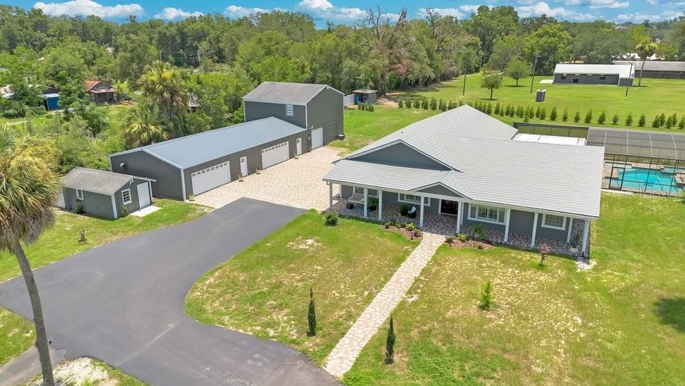 Aerial View of ADU, 6 car garage, Workshop (2 car space) and 2/1 guest unit with a loft and kitchenBrand new Hardie Board siding on ADU, metal  roof o