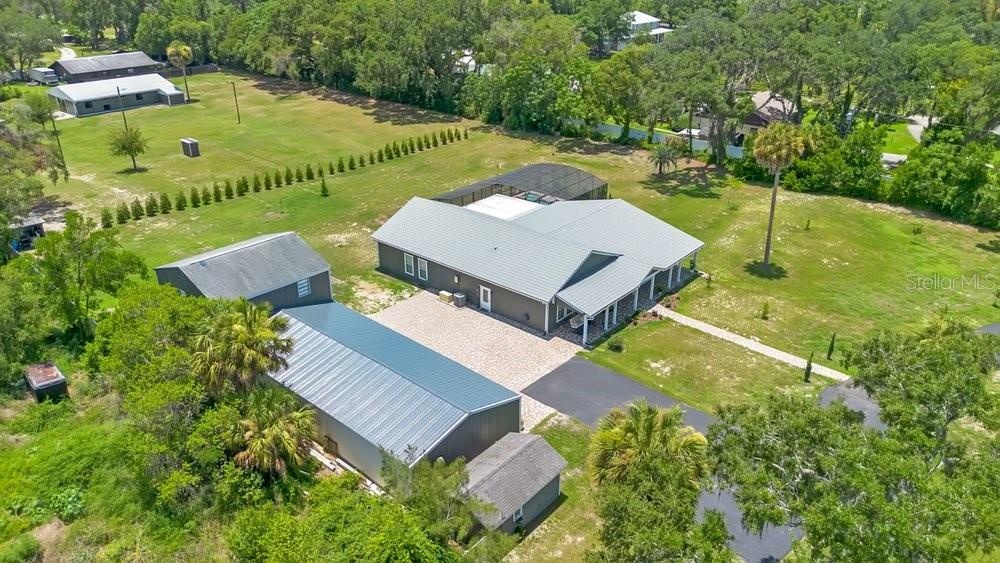 Aerial View of ADU, 6 car garage, Workshop (2 car space) and 2/1 guest unit with a loft and kitchenBrand new Hardie Board siding on ADU, metal roof on