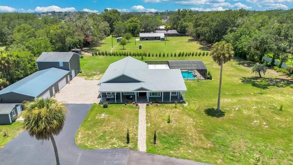Aerial View of ADU, 6 car garage, Workshop (2 car space) and 2/1 guest unit with a loft and kitchenBrand new Hardie Board siding on ADU, metal  roof o