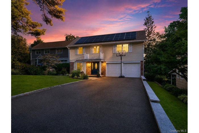 Front of home featuring attached 2 car garage and spacious driveway