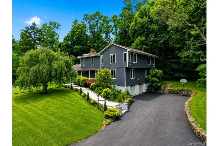 Contemporary two-story exterior with dark gray siding and white trim