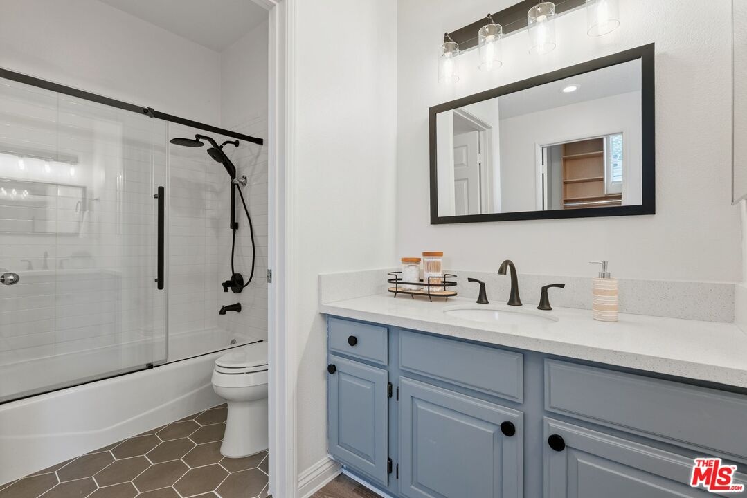 Bathroom featuring a grey vani