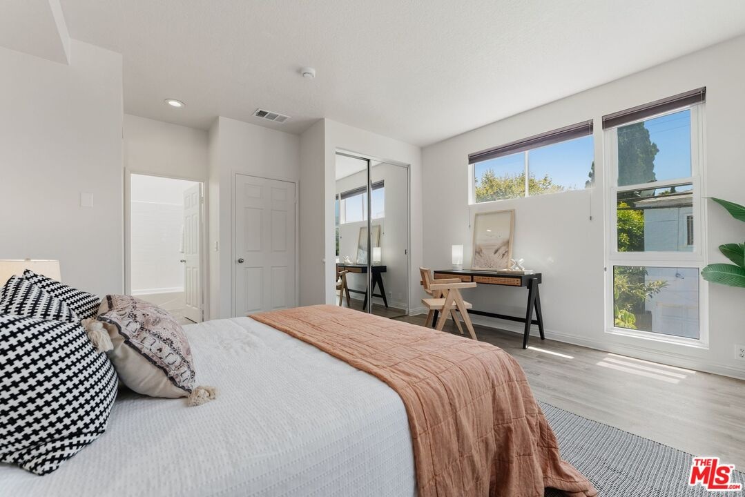 Bedroom offering wood-style fl